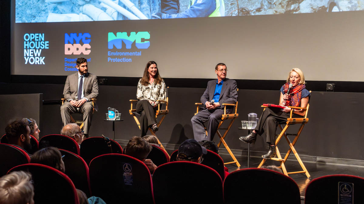 Four professionals sit on stage at a theatre in directors chairs for a panel conversation, with New York City agency logos on the theatre screen.